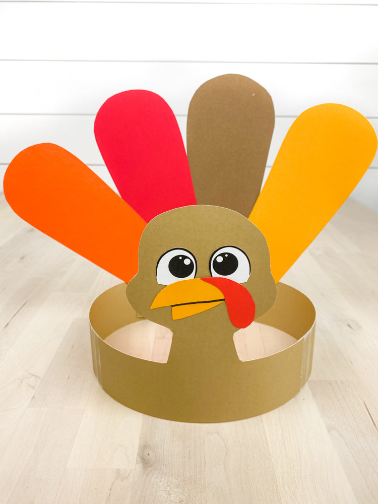 Turkey headband craft on wood table with white shiplap background