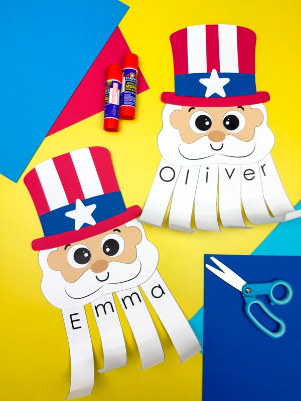 Two Uncle Sam name crafts on colorful background with glue sticks and scissors. 