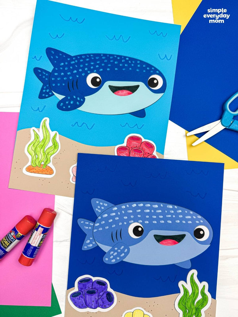 Two whale shark paper crafts on colorful background with scissors and glue