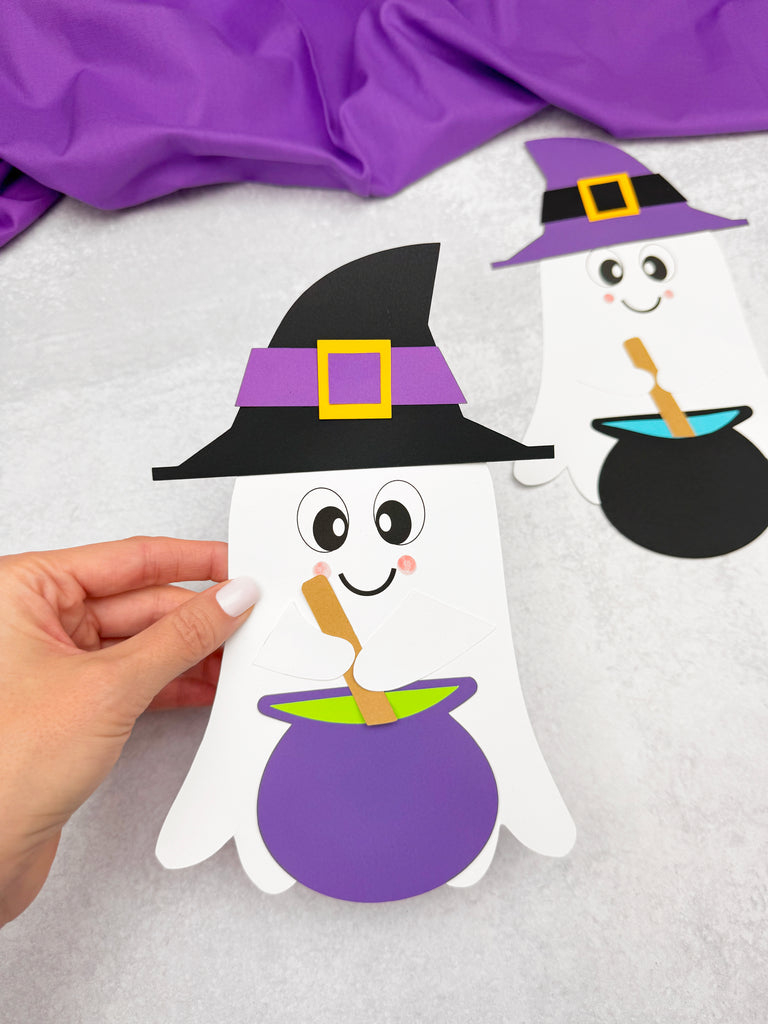 Halloween-themed ghost craft with witch hat and cauldron on a white background