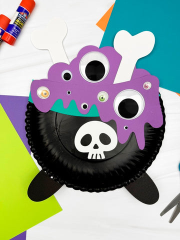 Halloween-themed craft project with purple and black design on a colorful background