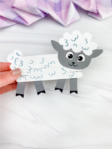 hand holding sheep popsicle stick craft